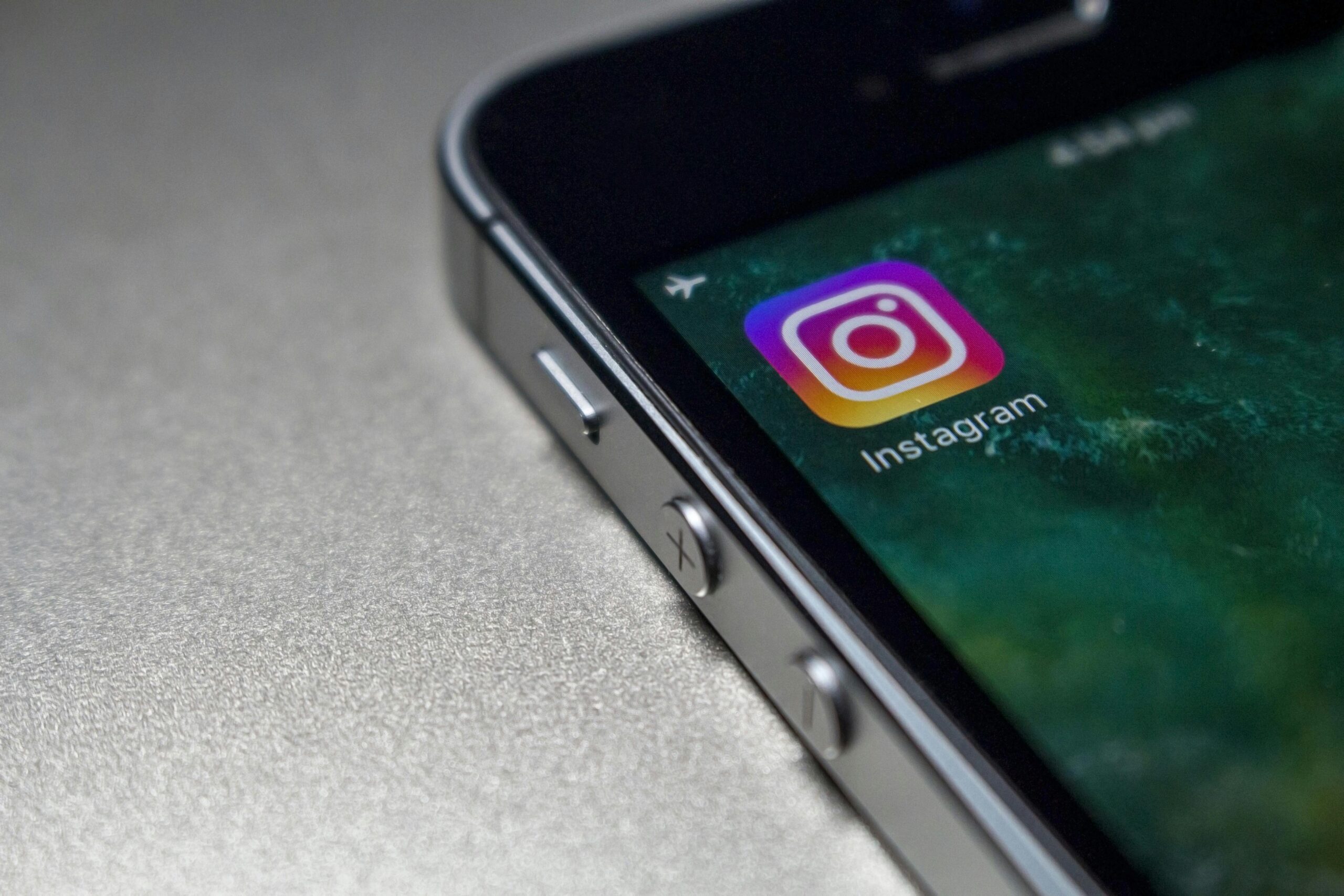 Close-up image of a smartphone screen displaying the Instagram app icon, emphasizing modern technology.